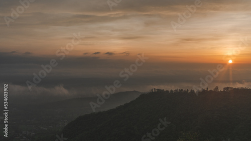 sunset over the mountains - sunrays on hills - scenic view of fog over mountains