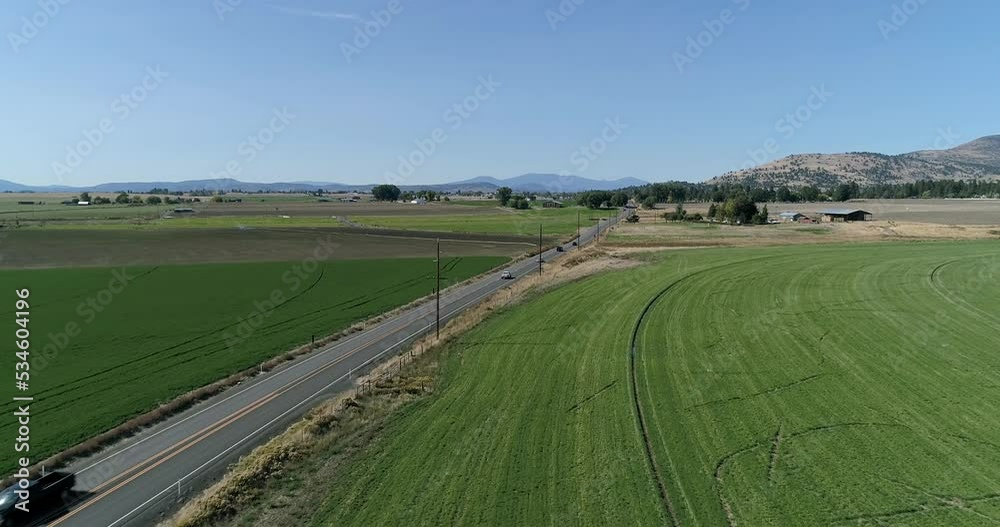 Aerial view of a slow road in a small farm town.
