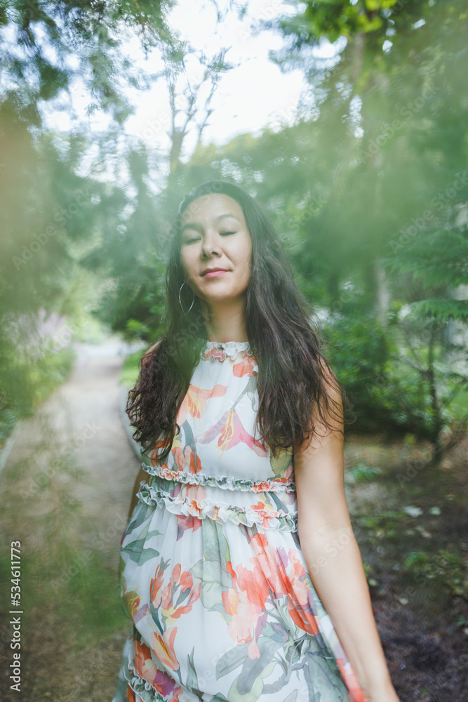 Happy mixed race Japanese woman in park. Eyes closed, defocused Happy mixed race Japanese woman in park. Eyes closed, defocused