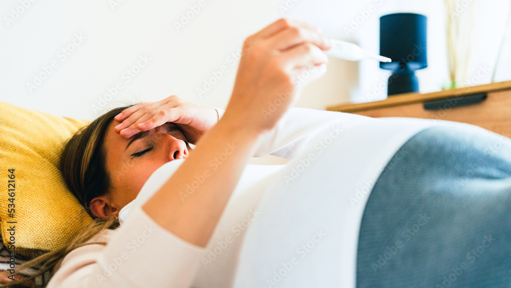 Pregnant temperature fever check. Pregnancy woman holding thermometer ...