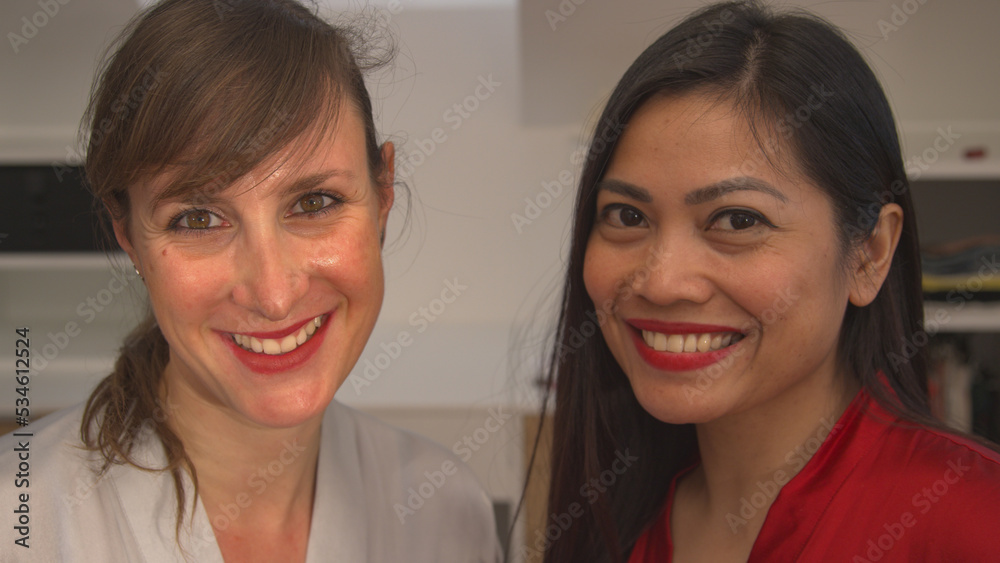 PORTRAIT: Cheerful young women ready for a night out after finishing make up PORTRAIT: Cheerful young women ready for a night out after finishing make up