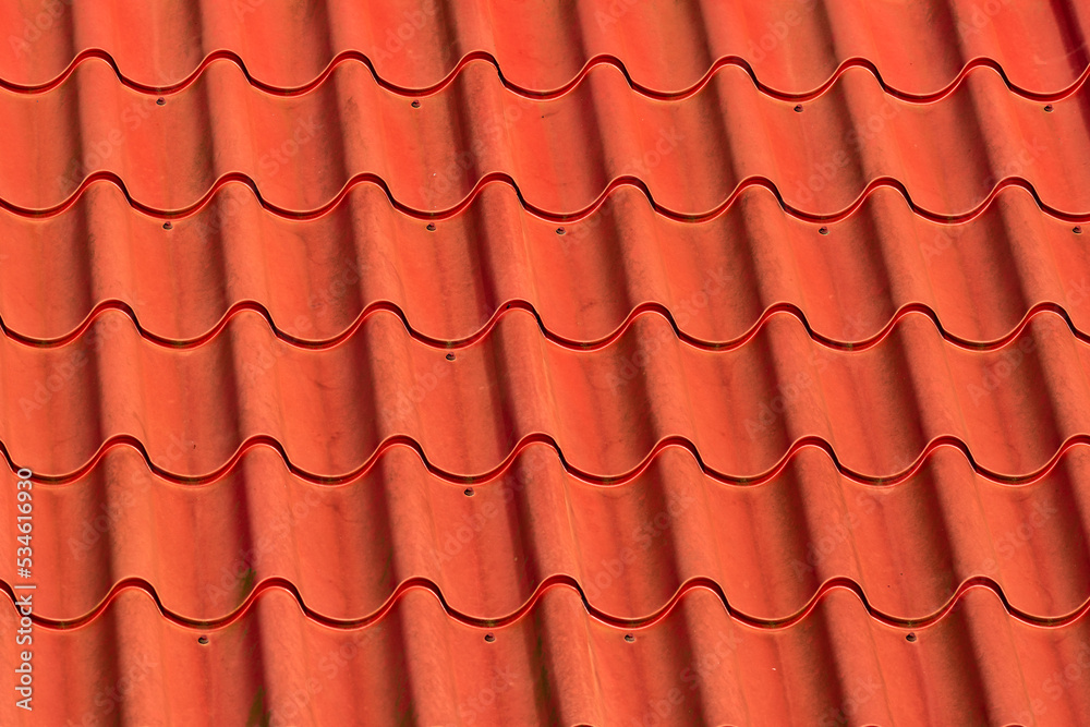 Red plastic roof tiles arranged geometrically Red plastic roof tiles arranged geometrically