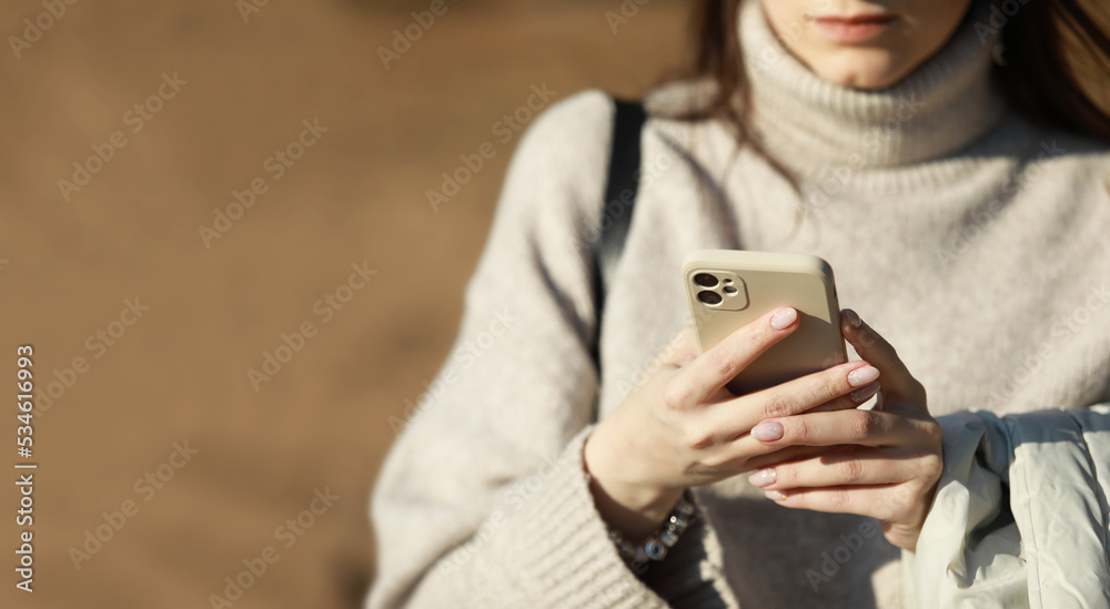Fototapeta premium a young girl prints a message beautiful warm background with space for text