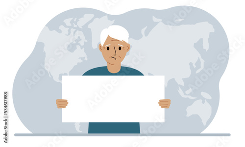 The concept of world attention. A man holds a white poster in his hands against the background of a world map.