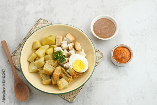 Batagor, Indonesian food made from fried fish dumpling, tofu, egg and potatoes with peanut sauce. 