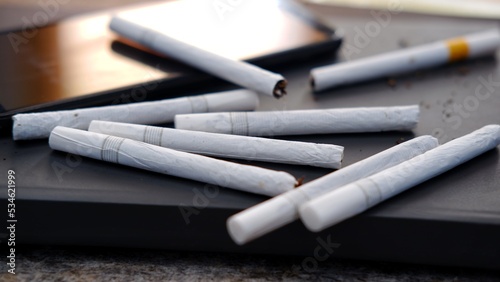 Many cigarettes stack on the table, a box of cigarettes. Unhealthy lifestyle concept and Drugs are harmful to the respiratory system.
