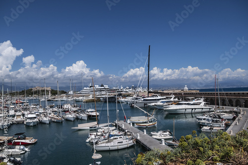 View of the Port Vauban in Antibes with moored sailboats and luxury yachts on the French Riviera in sunny weather. Antibes, Alpes-Maritimes, France. 