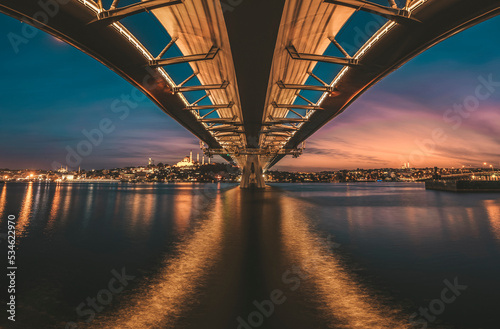Istanbul metro bridge view with a long exposure photography sunset lights on horizon and old city at background