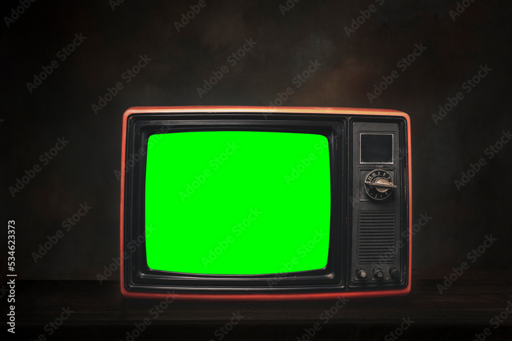 Old red retro TV It's still life with green screen in dark room Stock