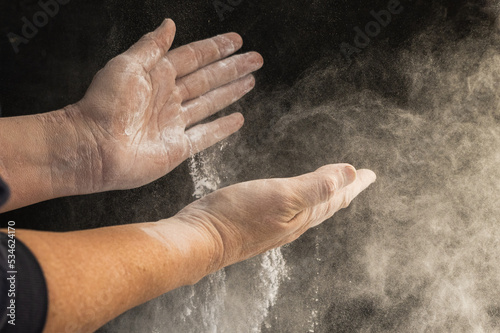 hands of unrecognizable person handling flour
