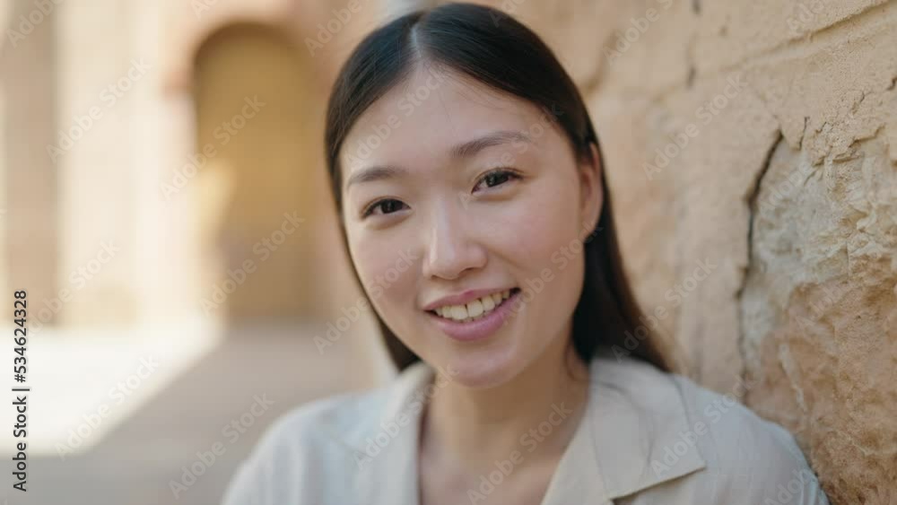 Chinese woman smiling confident standing at street Chinese woman smiling confident standing at street