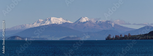 Snow capped volcanoes over lake Taupo