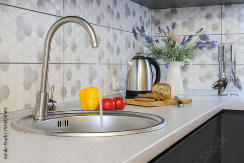 Faucet and steel sink in the kitchen