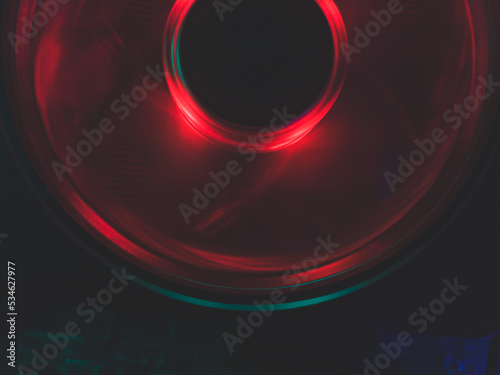 Red light of computer fan close up. cooler in action with leds. abstract background. power in motion concept