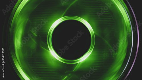 Computer cooling fan with green light close up. cooler in action with leds. power in motion concept. abstract background