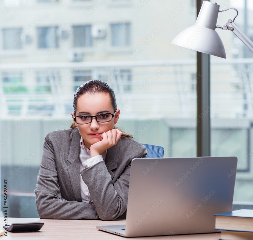 Businesswoman sitting at her desk in business concept Businesswoman sitting at her desk in business concept