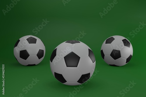 Three soccer balls isolated on green background © Tatang Sutari