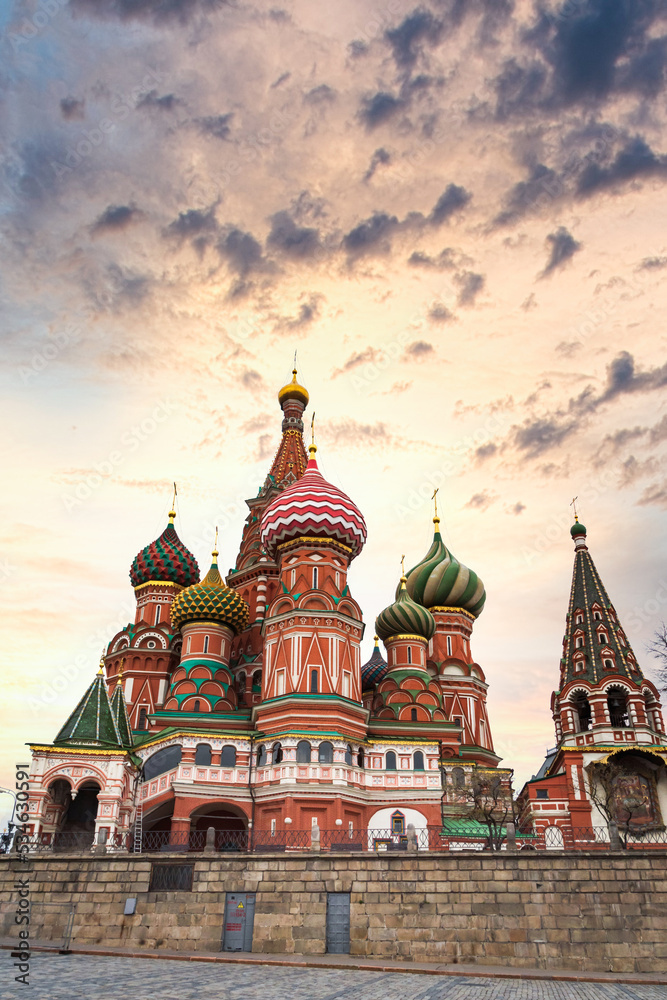 St Basil`s Cathedral on Red Square with dramatic sunset sky. St Basil`s temple is one of top tourist attractions of Moscow. 