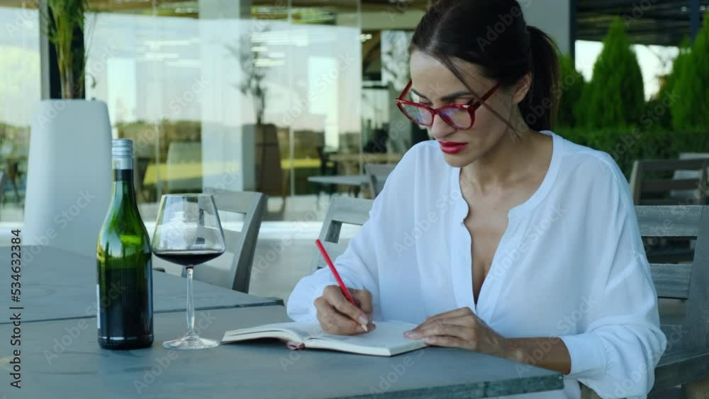 woman sommelier bartender smelling white wine and making degustation card. Young beautiful woman sommelier tasting red wine in wine cellar. woman smelling red wine aroma. woman sommelier bartender smelling white wine and making degustation card. Young beautiful woman sommelier tasting red wine in wine cellar. woman smelling red wine aroma.