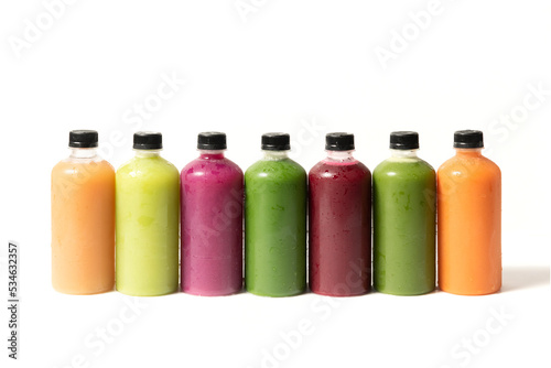 Set of organic cold pressed juice in bottles on white background