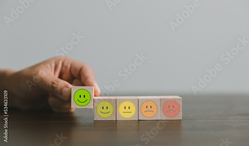 Satisfaction survey concept. Customer services best excellent business rating experience. Hand of business chooses a smile face on wood block circle. 5 Star Satisfaction. People feel great product.