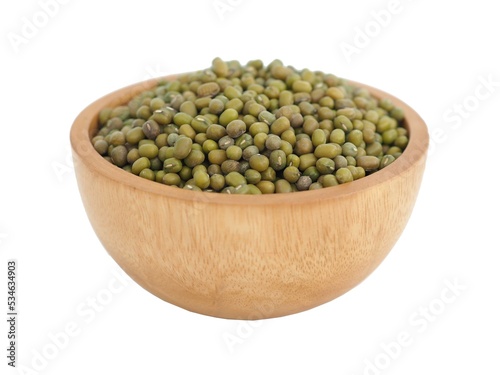 Mung beans in wooden bowl on white background. Closeup photo, blurred. photo