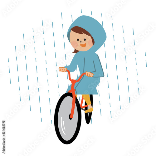 レインコートを着て自転車に乗る女性