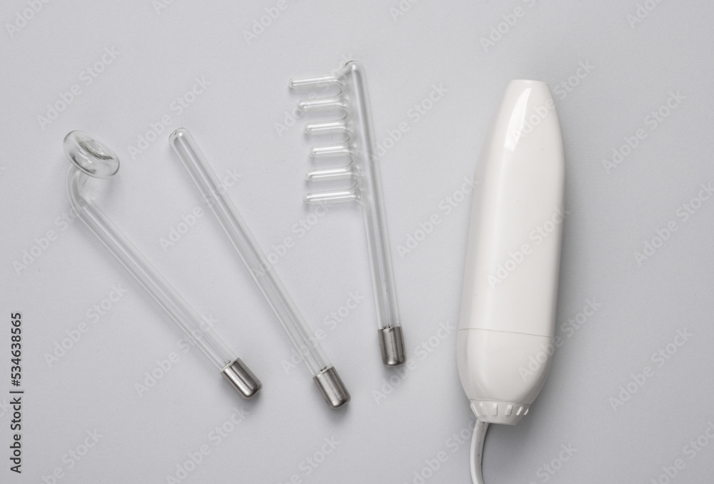Device for local darsonvalization on gray background. Treatment of acne, problem skin. Top view. Flat lay composition