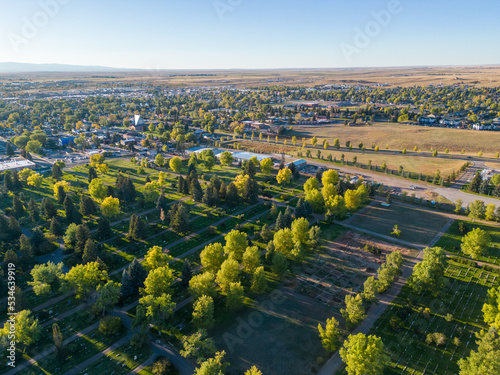 Green Summer Cemetery from air aerial drone image with city and buildings in background in Laramie Wyoming photo