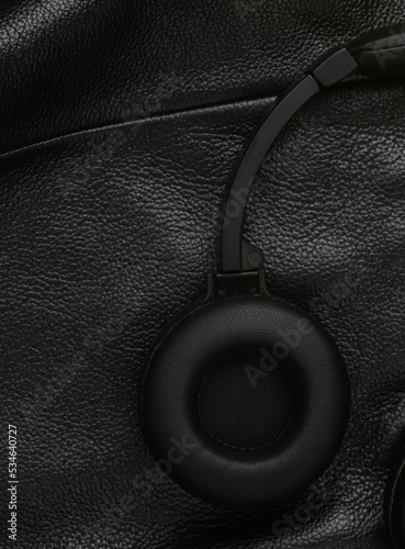 Headphones on black leather surface