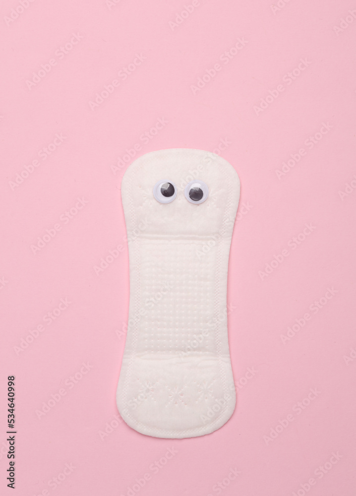 Intimate pad with eyes on a pink background. Creative idea Intimate pad with eyes on a pink background. Creative idea