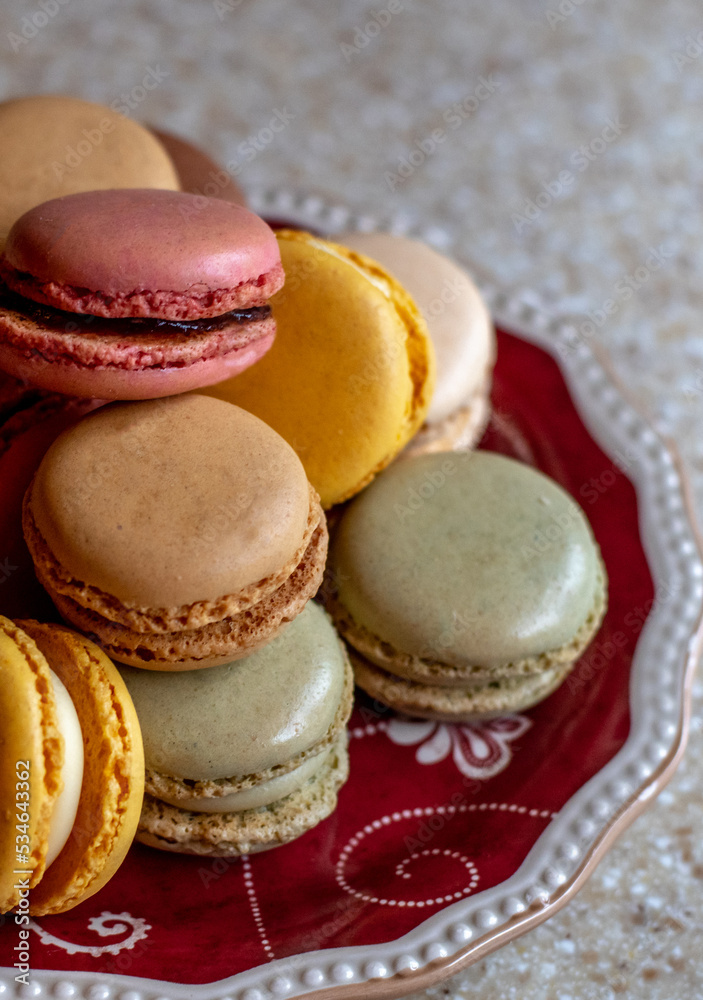 plate of sweet filled cookies called macarons, made with egg white and ground almonds plate of sweet filled cookies called macarons, made with egg white and ground almonds
