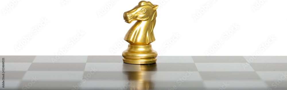 Golden horse chess on a chessboard. Golden horse chess on a chessboard.
