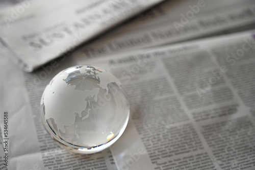 ガラスの地球儀と新聞　東アジア周辺　世界情勢のイメージ　glass globe (East Asia ) on newspapers