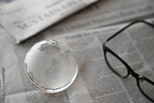 ガラスの地球儀と新聞　東アジア周辺　世界情勢のイメージ　glass globe (East Asia ) on newspapers