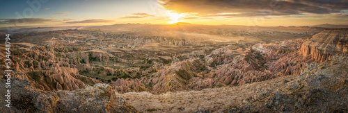 Panoramic soft dramatic sunrise over the red and rose valleys with aerial view down from canyon. Textures and beautiful Capapdocia landscape. Background image.