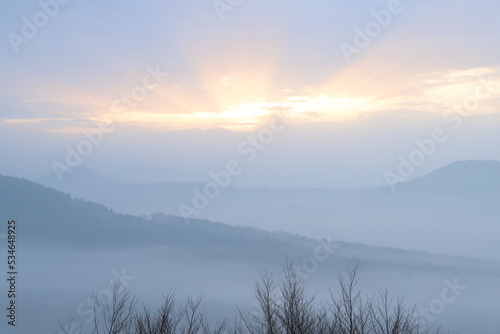 Sunrise in autumn with fog and clouds. Viewpoint in the Palatinate Forest. Morning mood in nature. Landscape shot on a mountain