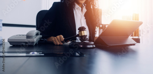 justice and law concept.Male judge in a courtroom on wooden table and Counselor or Male lawyer working in office. Legal law, advice and justice concept.