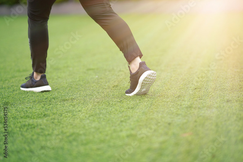woman ,runner run with shoe on lawn grass
