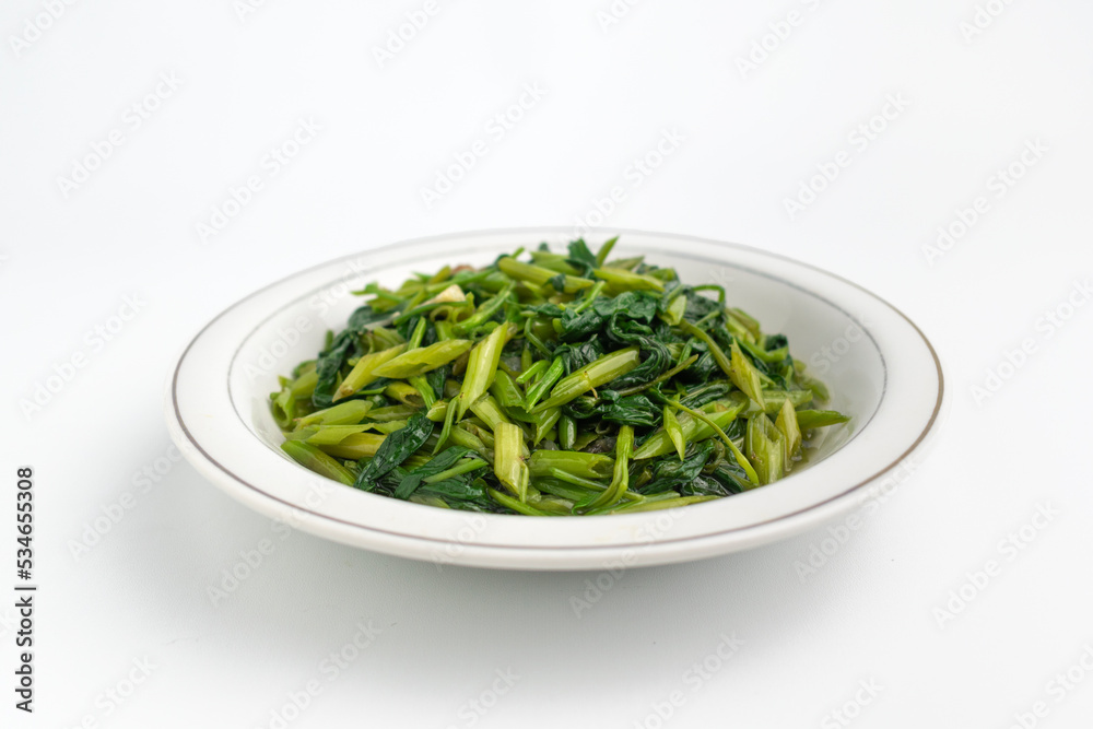 stir fried water spinach vegetable or Tumis Kangkung on white plate isolated on white background stir fried water spinach vegetable or Tumis Kangkung on white plate isolated on white background