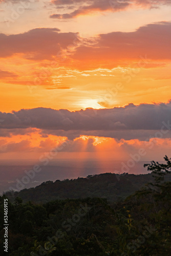 Beautiful sunset from the top of the hill, the sky is golden with clouds around it, the view is really amazingBeautiful sunset from the top of the hill, the sky is golden with clouds around it, the vi photo