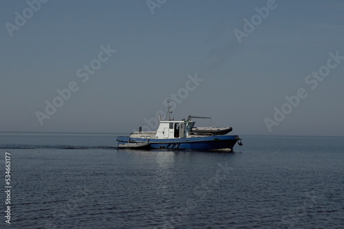 large fishing boat with inflatable boats on a bolt in the White Sea