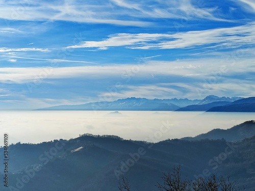 Fototapeta Naklejka Na Ścianę i Meble -  Fog on the plain of Friuli and view of Piancavallo and the Alps at sunset from Mount Bernadia in Tarcento