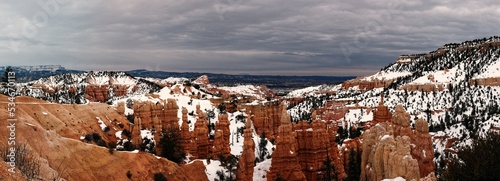 Bryce canyon panorama in overcast winter day with orange rocks and snow