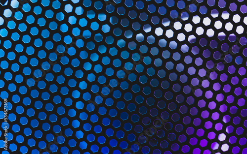 Led lights shines through the ventilation grid holes of computer air cooling system. abstract futuristic colorful background