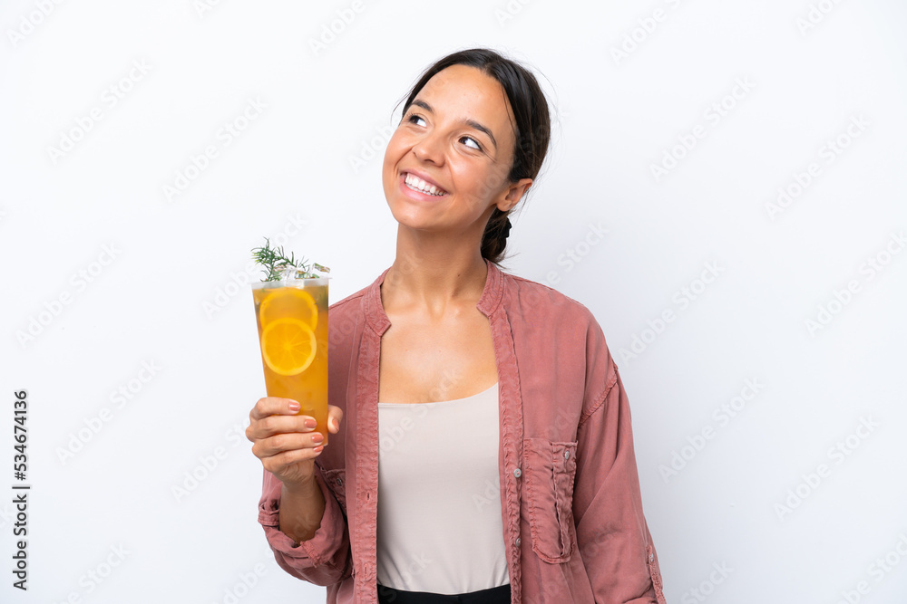 Young hispanic woman holding a cocktail isolated on white background thinking an idea while looking up Young hispanic woman holding a cocktail isolated on white background thinking an idea while looking up