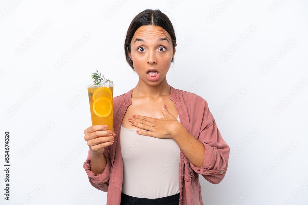 Young hispanic woman holding a cocktail isolated on white background with surprise facial expression Young hispanic woman holding a cocktail isolated on white background with surprise facial expression