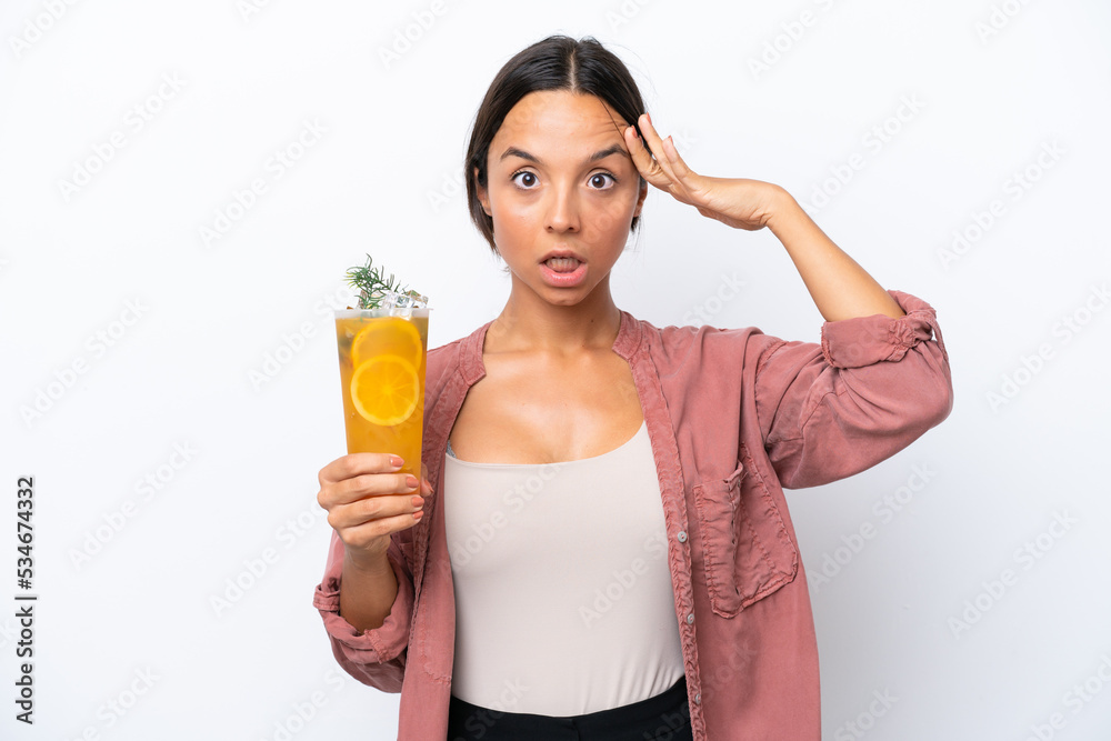 Young hispanic woman holding a cocktail isolated on white background with surprise expression Young hispanic woman holding a cocktail isolated on white background with surprise expression