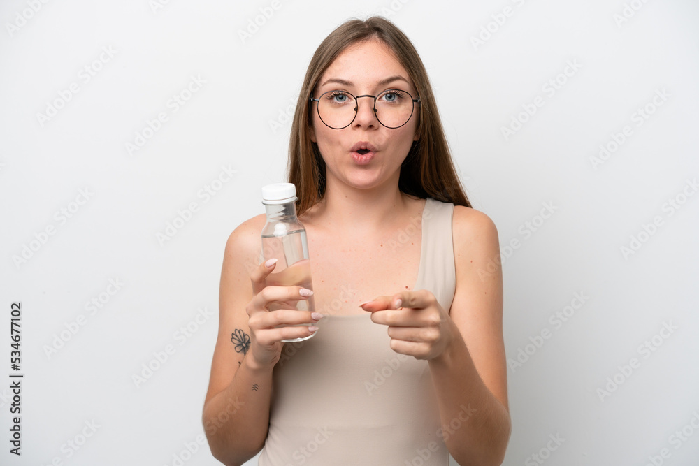 Young Lithuanian woman with a bottle of water isolated on white background surprised and pointing front Young Lithuanian woman with a bottle of water isolated on white background surprised and pointing front