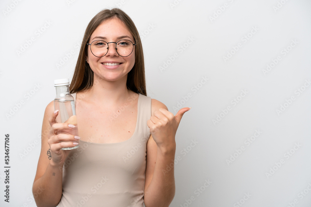 Young Lithuanian woman with a bottle of water isolated on white background pointing to the side to present a product Young Lithuanian woman with a bottle of water isolated on white background pointing to the side to present a product